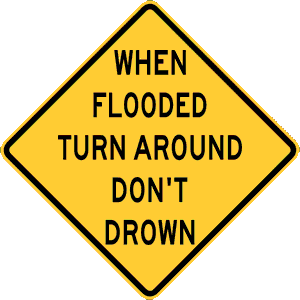 Yellow caution sign saying When Flooded Turn Around Don't Drown