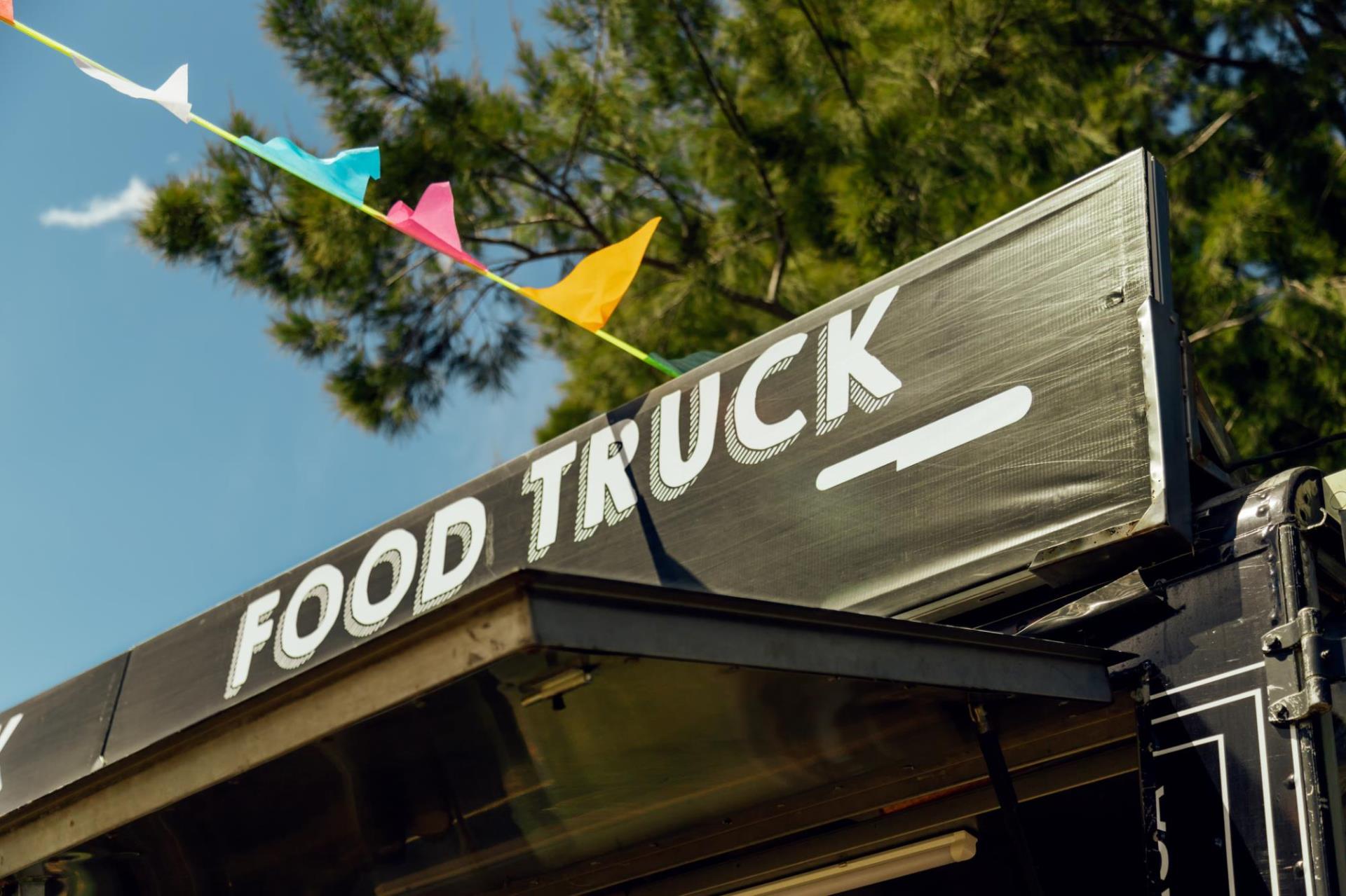 The top section of a food truck with streaming rally flags