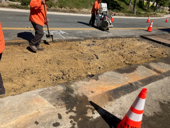 City Street Maintenance Employees Removing Asphalt