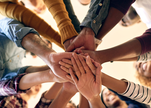 group of hands overlapping and together